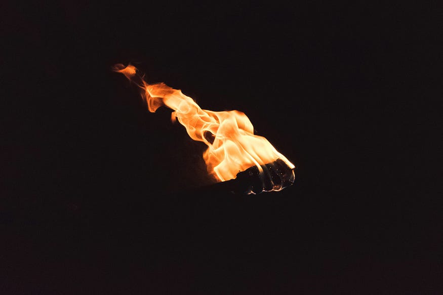 A burning ember flying through the sky, so that it appears to have a tail behind it.