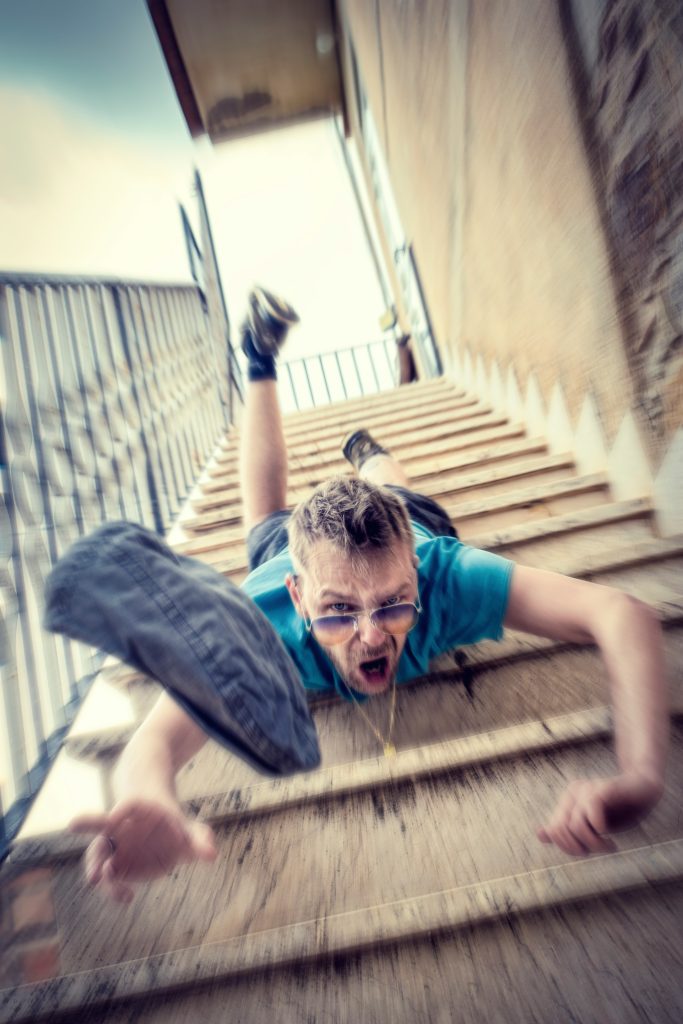 Man falling head first down the stairs.
