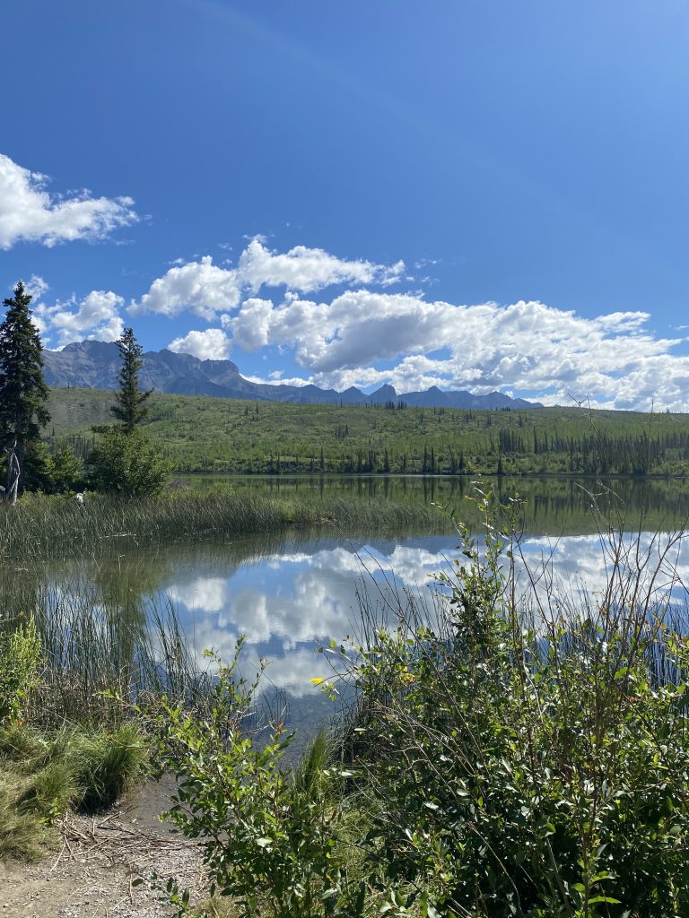 Lake with mountains and clear blue sky