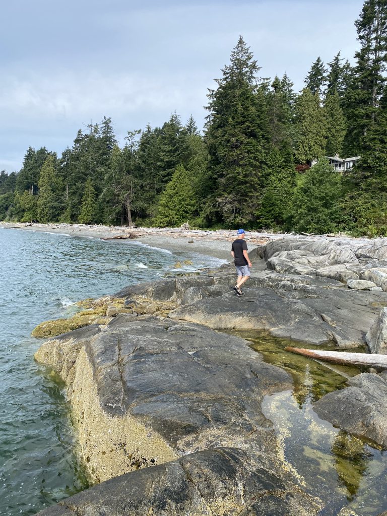 Man walking along beach
