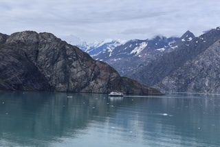 small boat near glaciers in Alaska