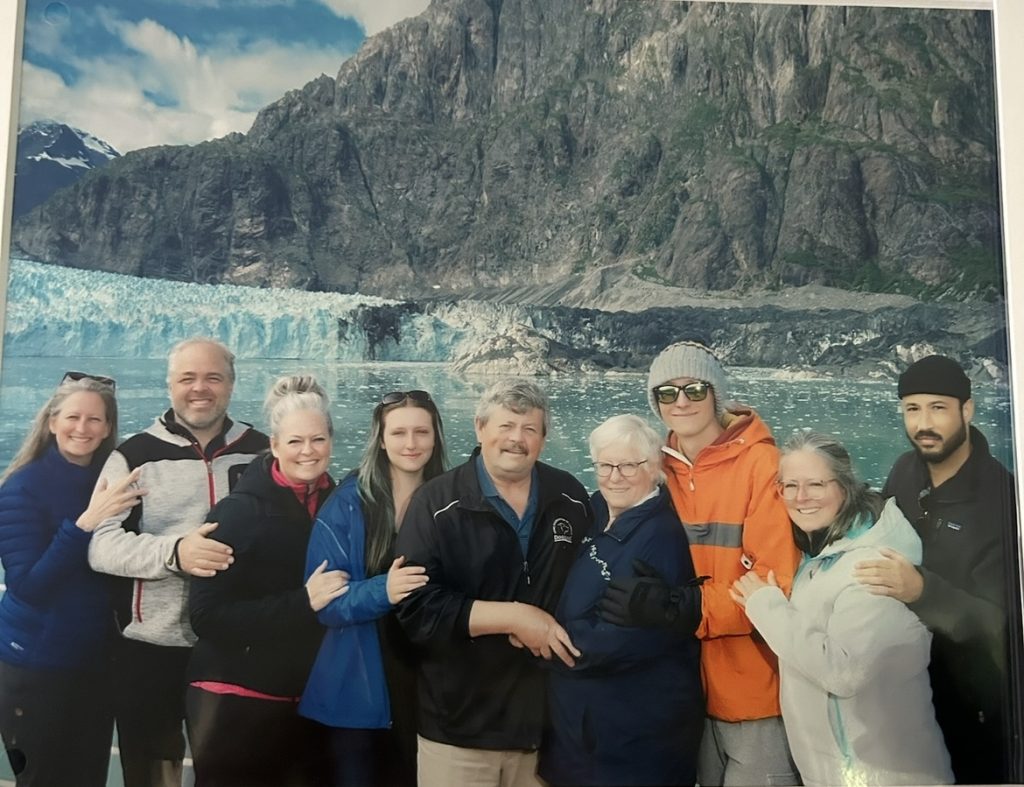 family in front of glacier