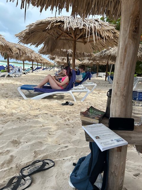 two teens reading on beach