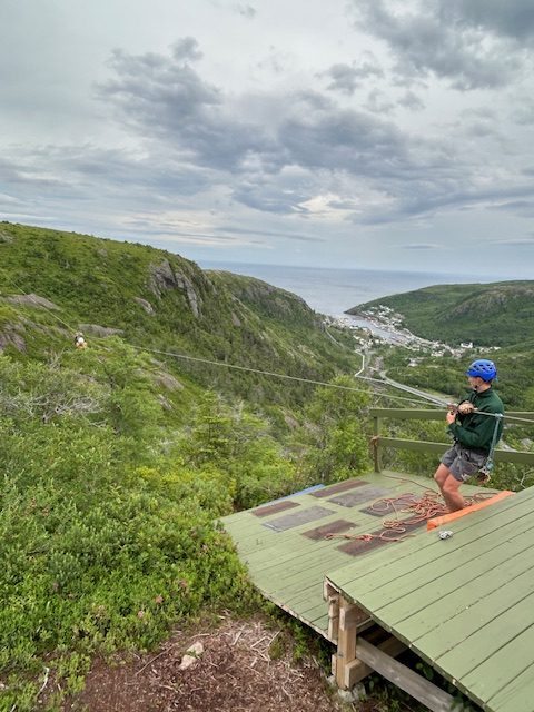 zipline and view of small town and ocean