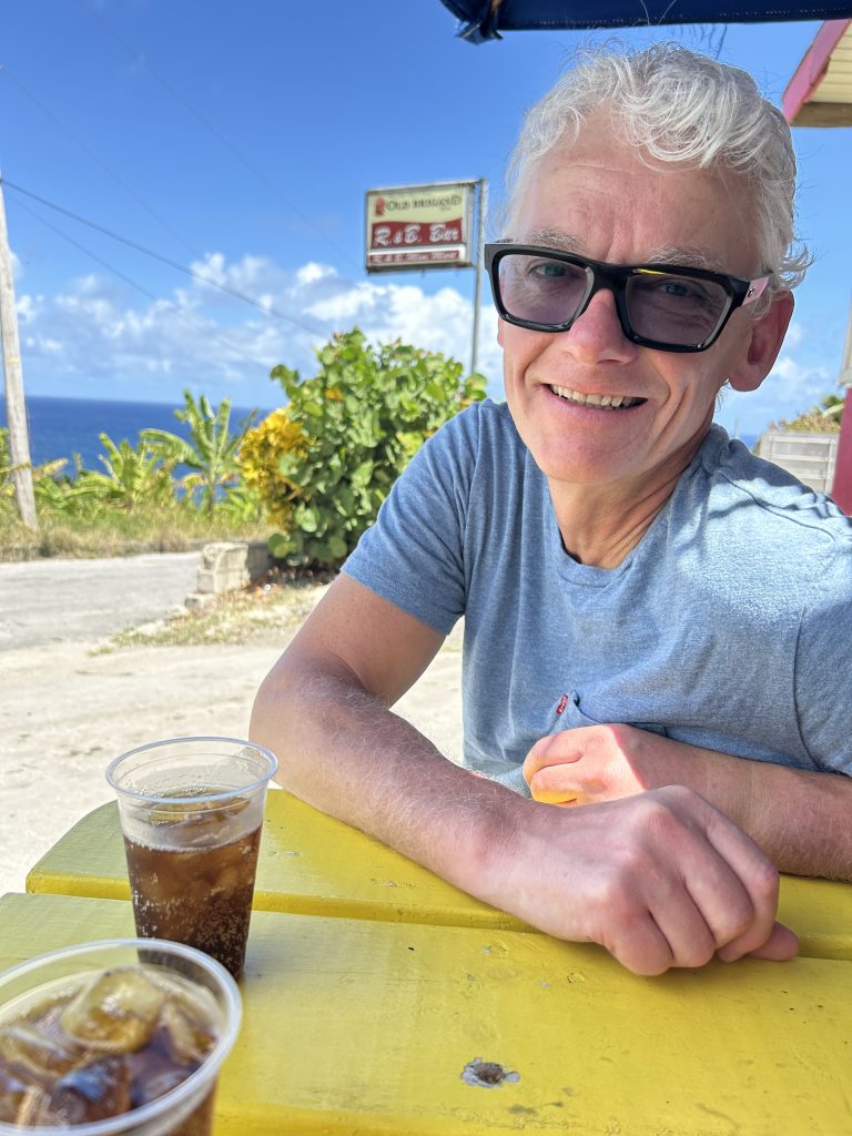Man with rum at picnic table