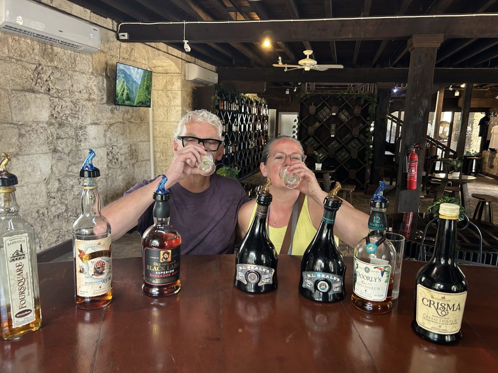 Two people taste testing rum