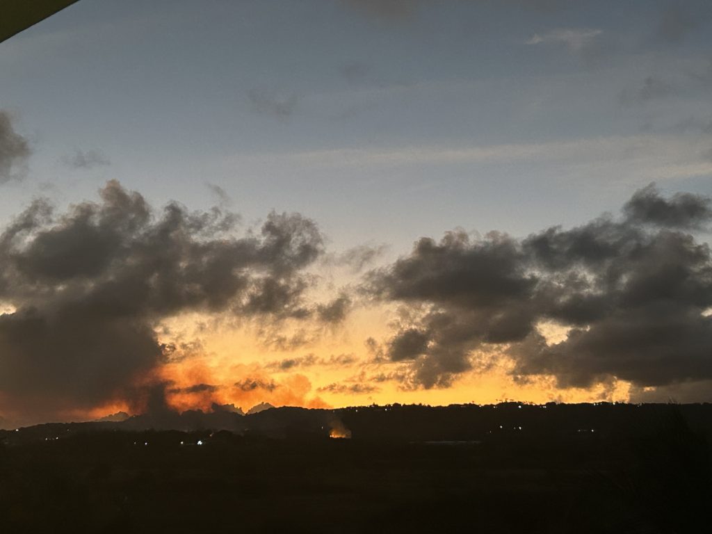 Sunset, fires in the background.
