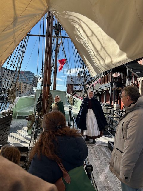 two women dressed up on a ship