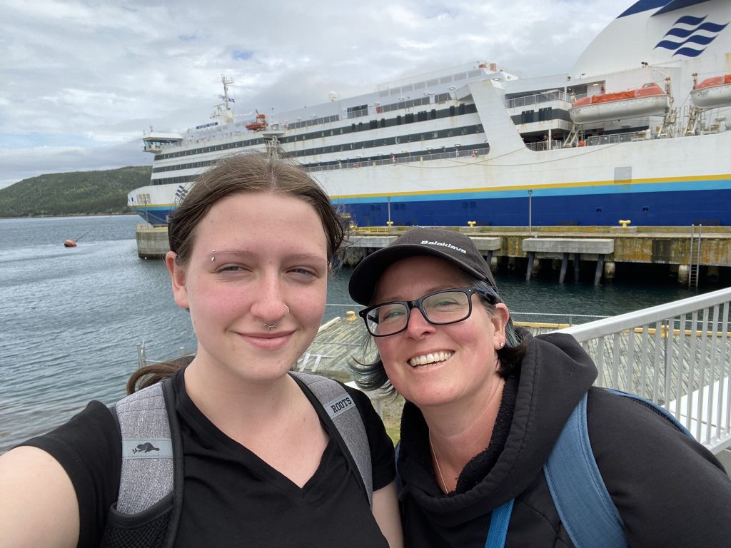 two women with ferry in background