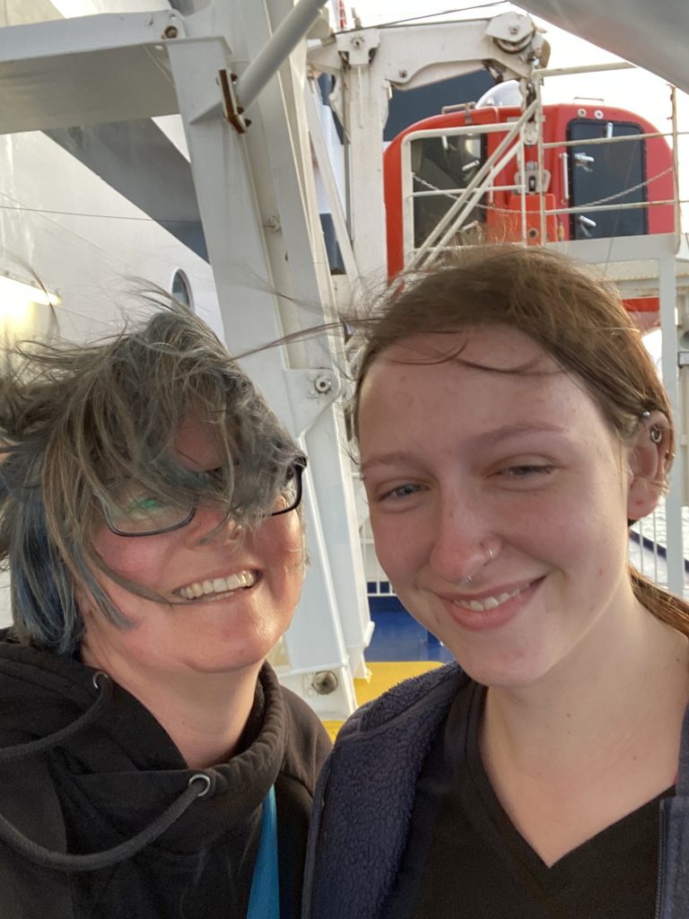 two women with hair in face from wind