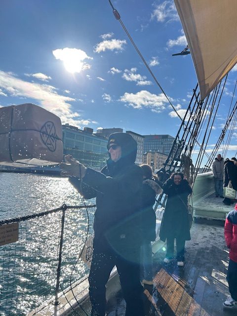 man tossing box overboard