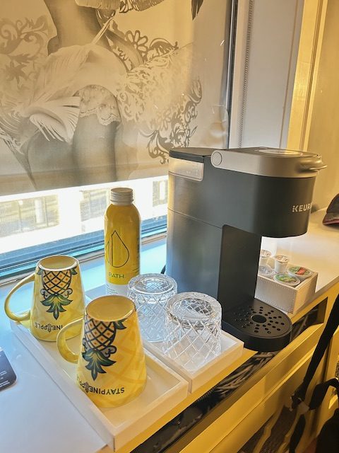 colourful mugs and coffee maker in hotel room