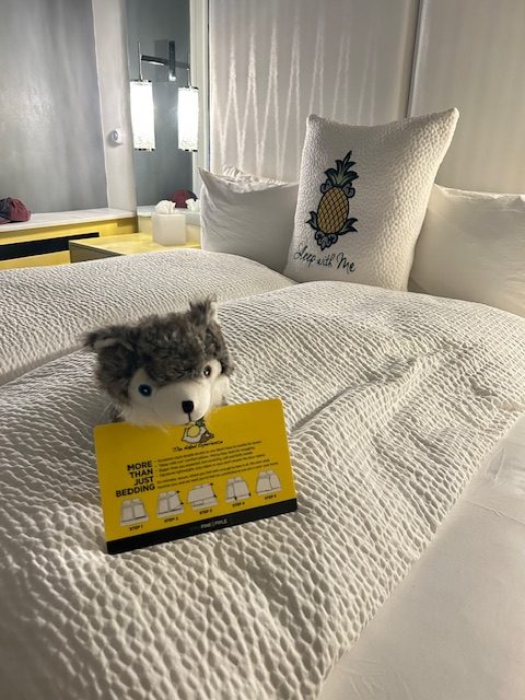 stuffed dog on bed in hotel