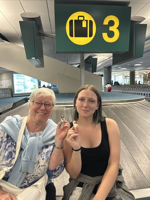 two women with tiny Jesus in airport