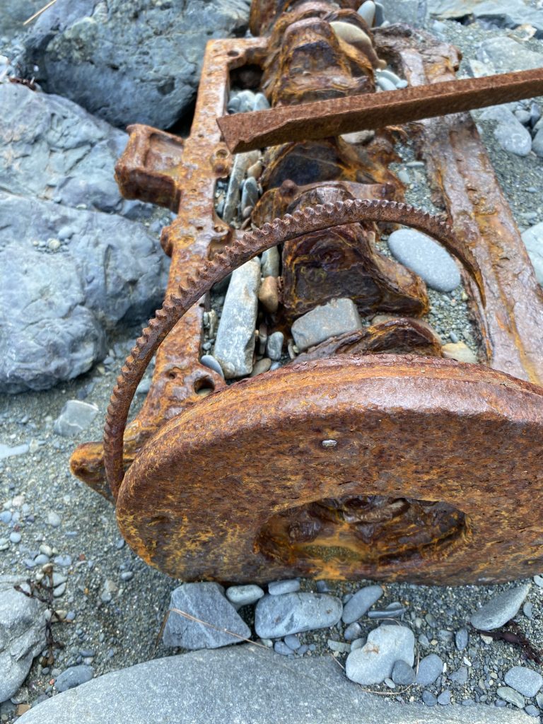 Rusty parts on sandy beach