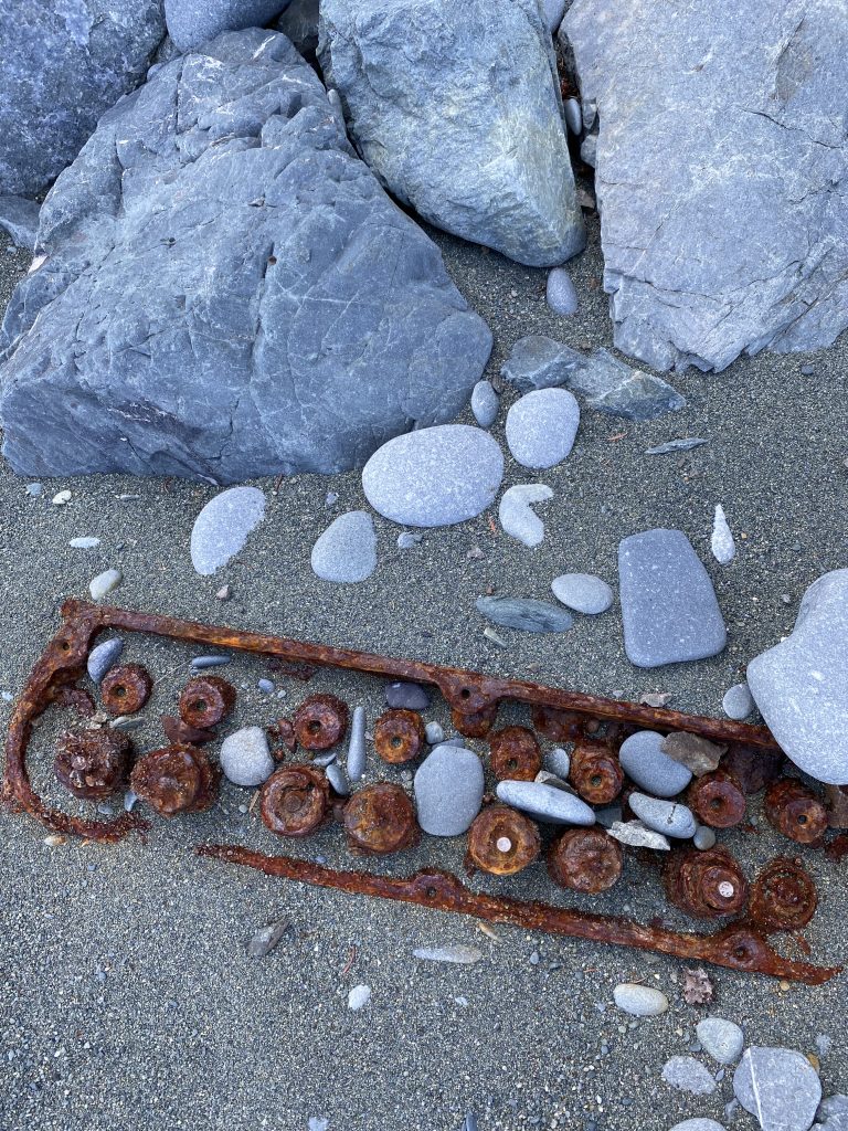 rusty ship part on sandy beach