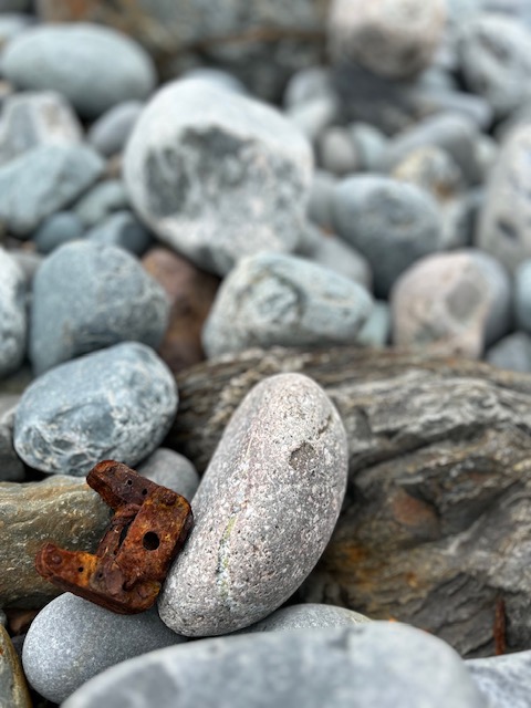 Rusty piece amongst rocks on beach